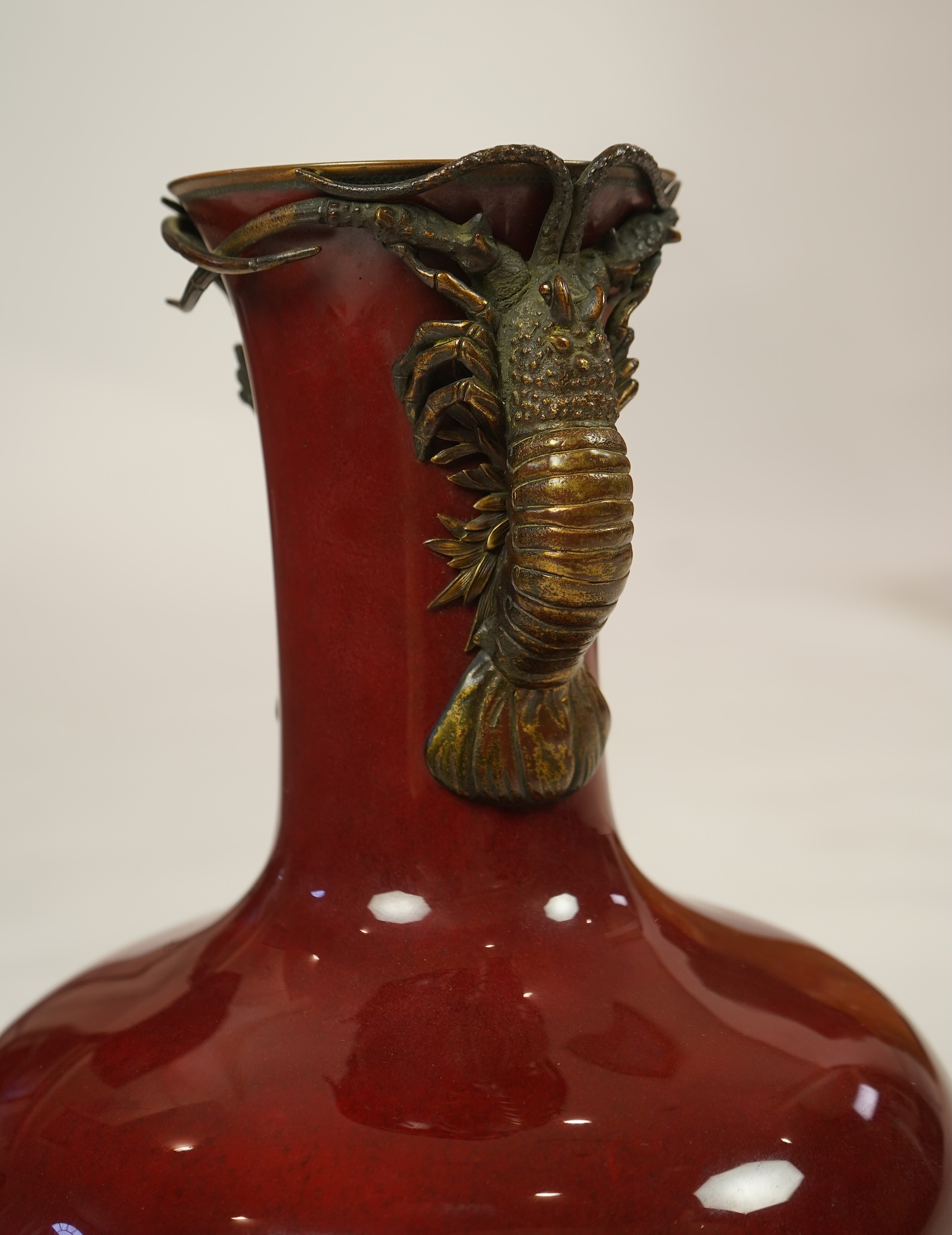 An unusual Japanese sang-de-boeuf ground cloisonné enamel and gilt metal mounted vase